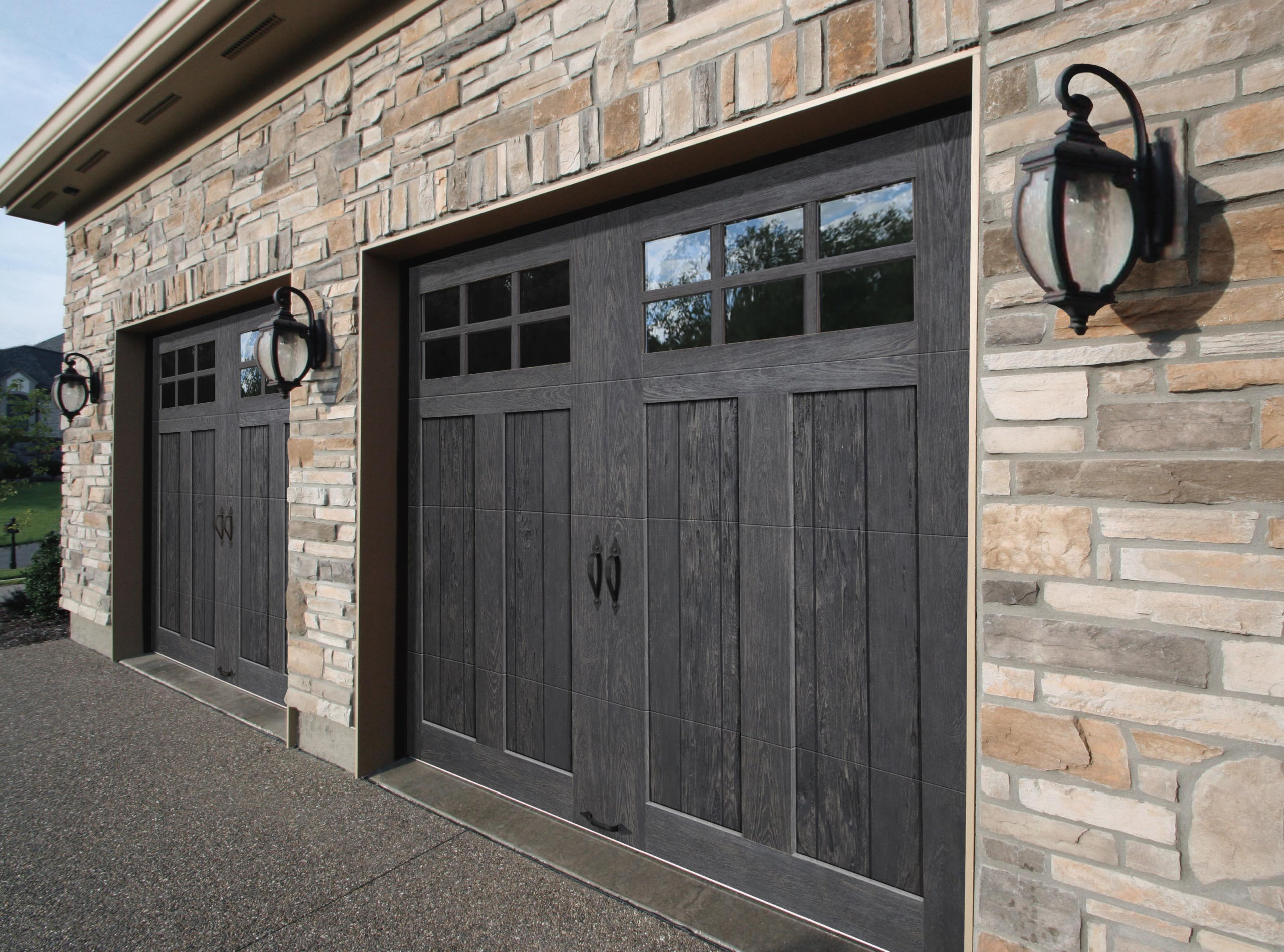 grey or black faux wood garage doors with windows by clopay