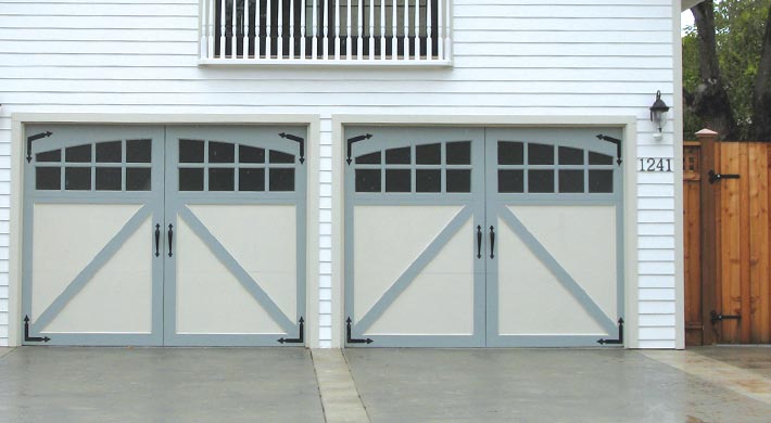 two tone garage door with windows and hardware