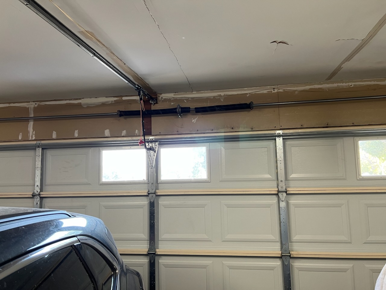 Repairing broken spiring to fix garage door bouncing