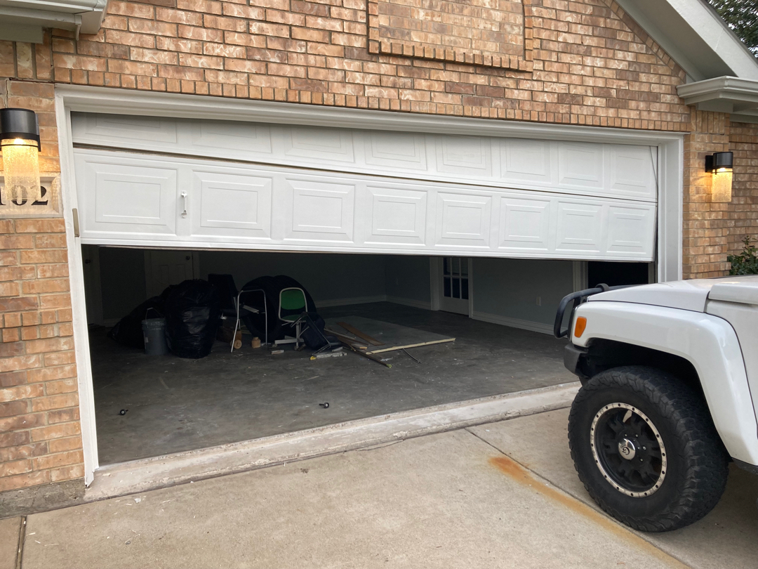 Repairing misaligned tracks to fix garage door bouncing