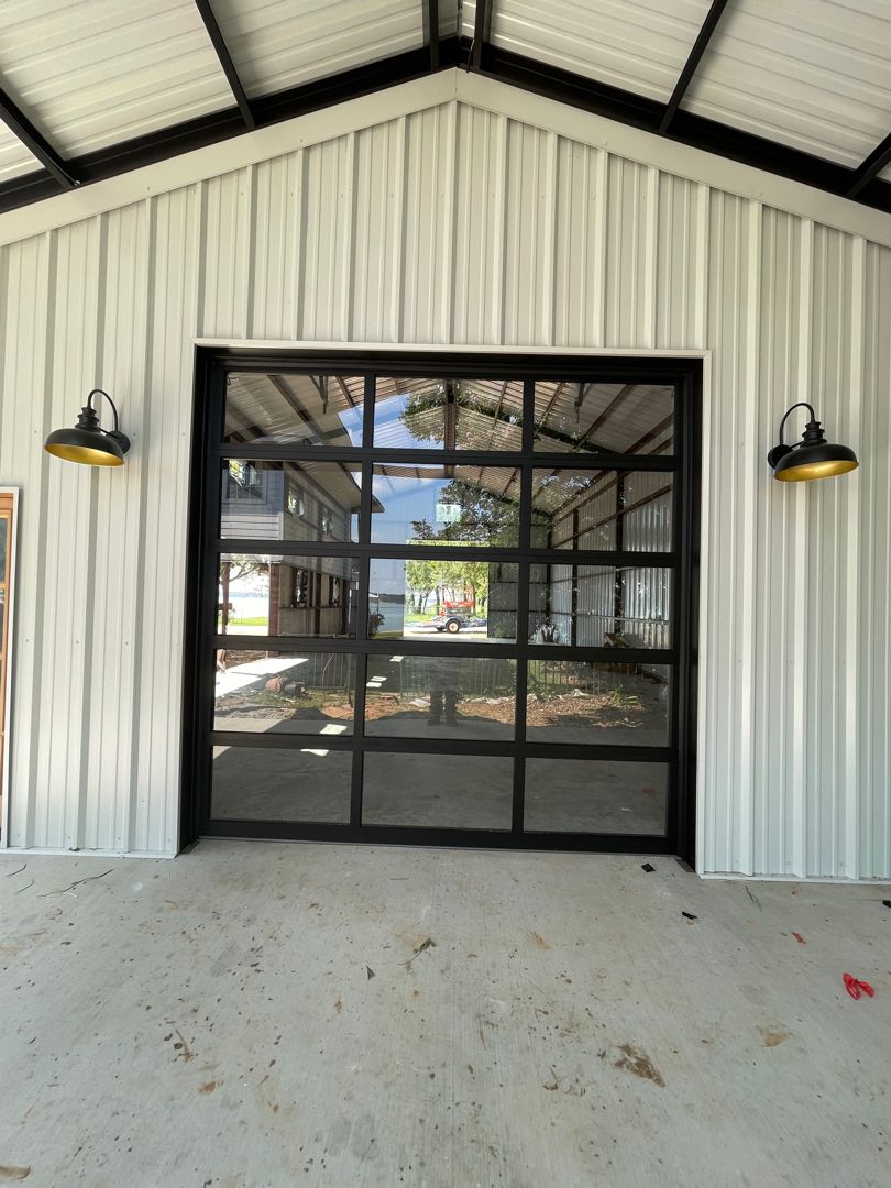 10x0 black full view garage door with a white building installed by doorvana garage doors in bridgeport texas