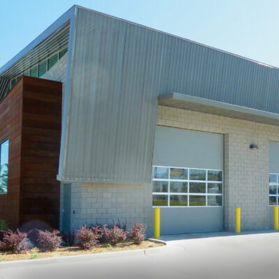 The building features multiple Amarr 2042 commercial garage doors with glass panels