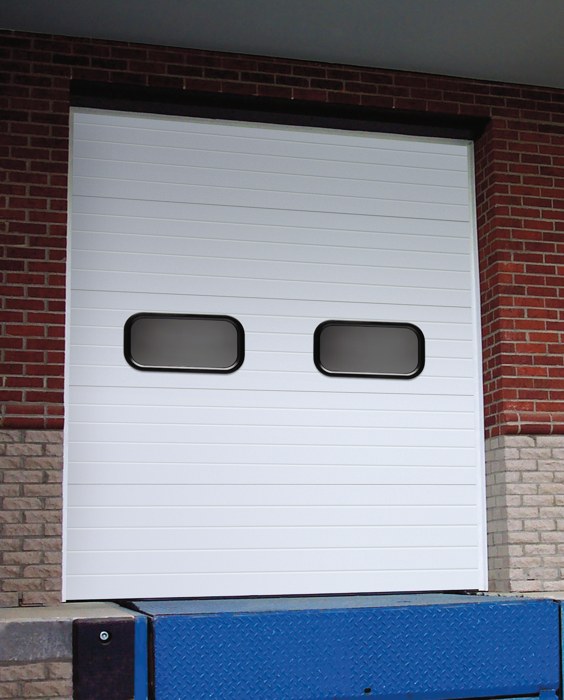 A white Amarr 2742 commercial steel sectional garage door with two small rectangular windows near the top.