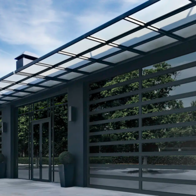 A modern building with large Clopay Architectural Series-Aluminum glass garage doors and a metal awning