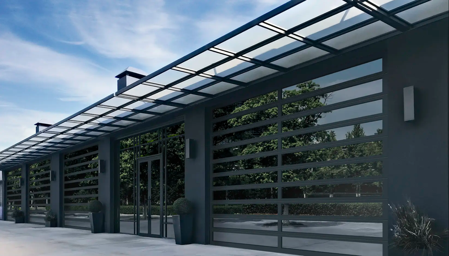 A modern building with large Clopay Architectural Series-Aluminum glass garage doors and a metal awning