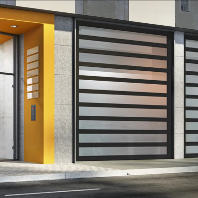 A modern storefront with large Clopay Architectural Series-Aluminum glass garage doors and a bright yellow accent wall