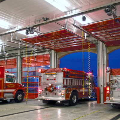 A modern fire station with several Clopay Architectural Series-Aluminum glass bay doors