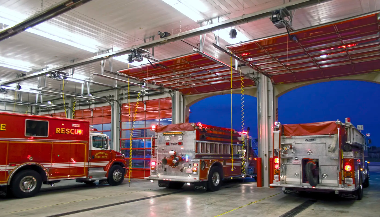 A modern fire station with several Clopay Architectural Series-Aluminum glass bay doors