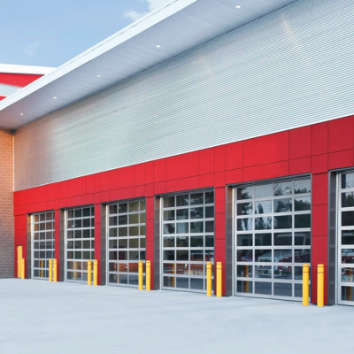 A modern fire station with multiple Clopay Architectural Series-Aluminum glass garage doors and red accents