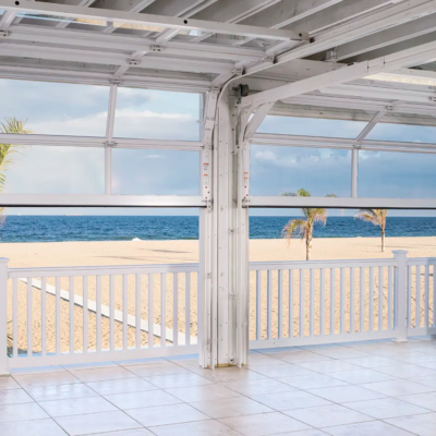 An open-air beachfront event space with multiple large Clopay Architectural Series-Aluminum glass garage doors