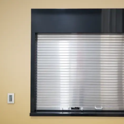 A silver Clopay Counter and Shutter Door covering a service counter