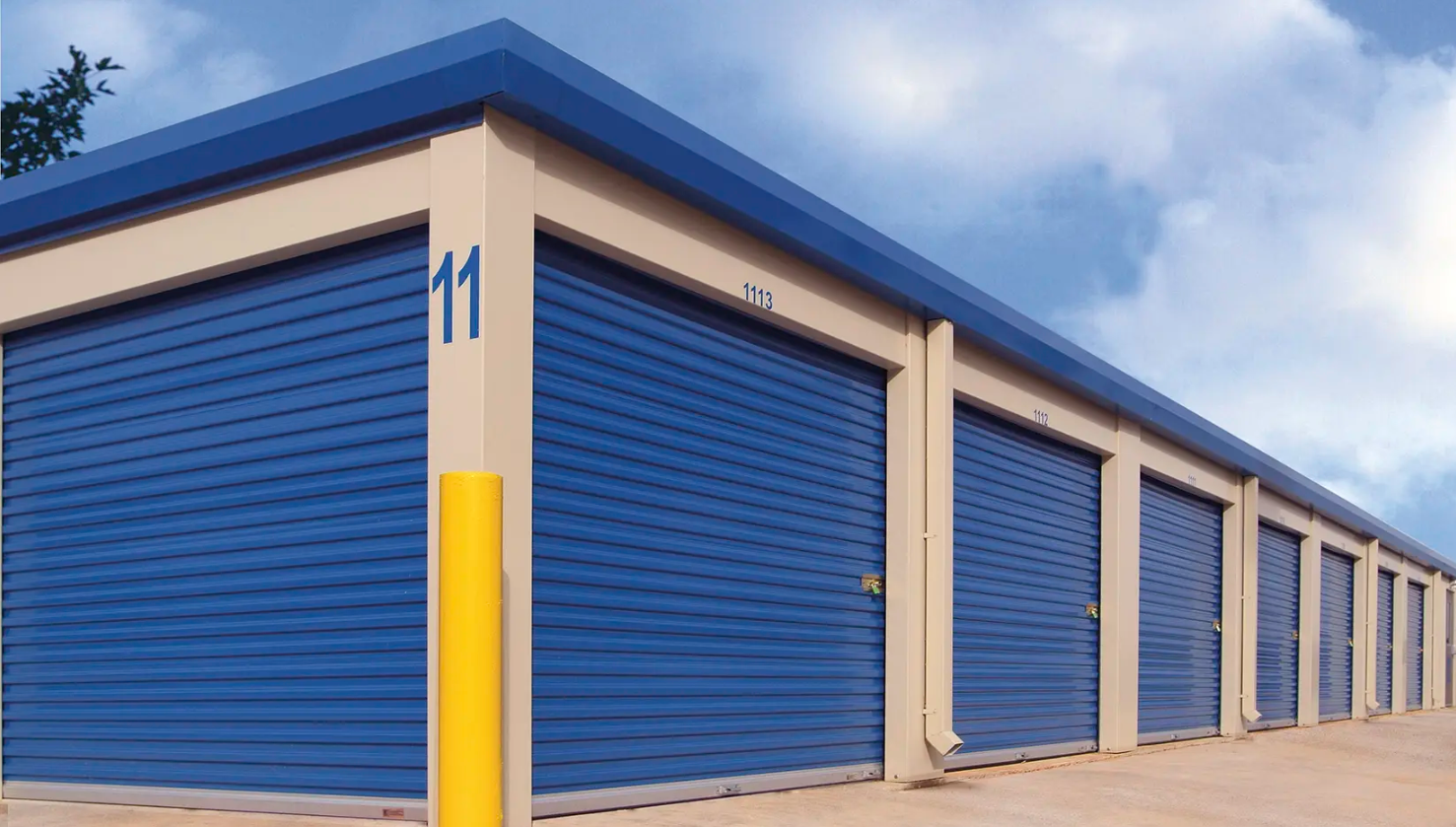 A row of blue self-storage Clopay Rolling Sheet Doors units with roll-up doors