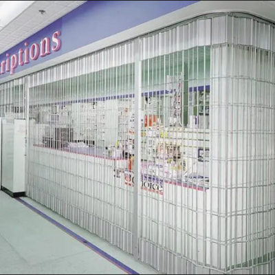 Metal Clopay Security Grille Doors in front of a pharmacy counter