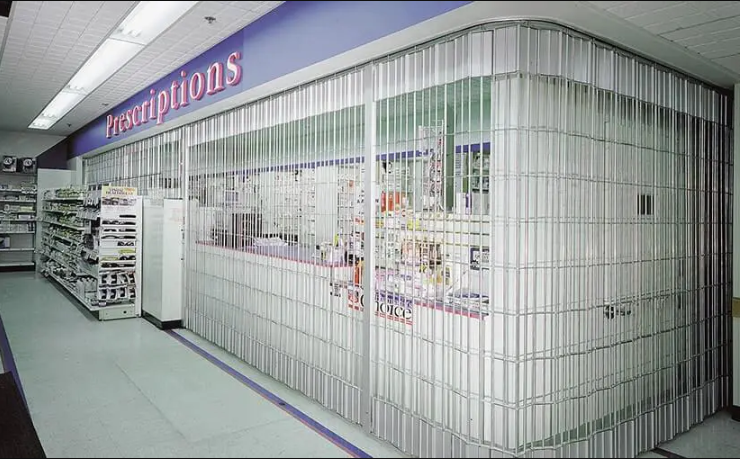 Metal Clopay Security Grille Doors in front of a pharmacy counter