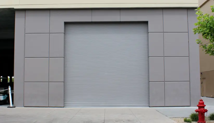 A large gray roll-up door on a commercial building.