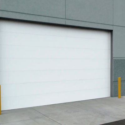 A large white commercial Clopay Energy Series garage door on a modern building