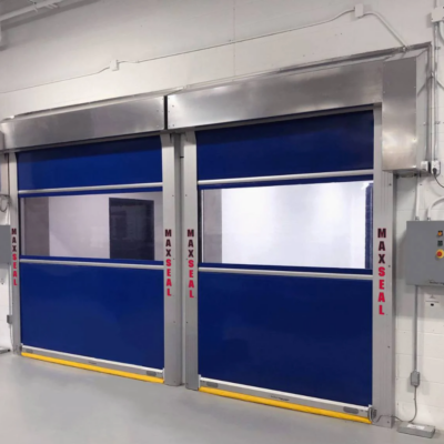 A pair of blue high-speed industrial doors with clear panels, labeled "MAXSEAL".