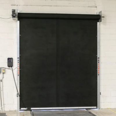 A black MaxPro industrial door with a metal frame installed on a white wall.