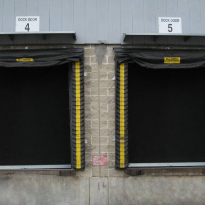 Two loading dock doors labeled 4 and 5 with black curtains and yellow safety stripes.