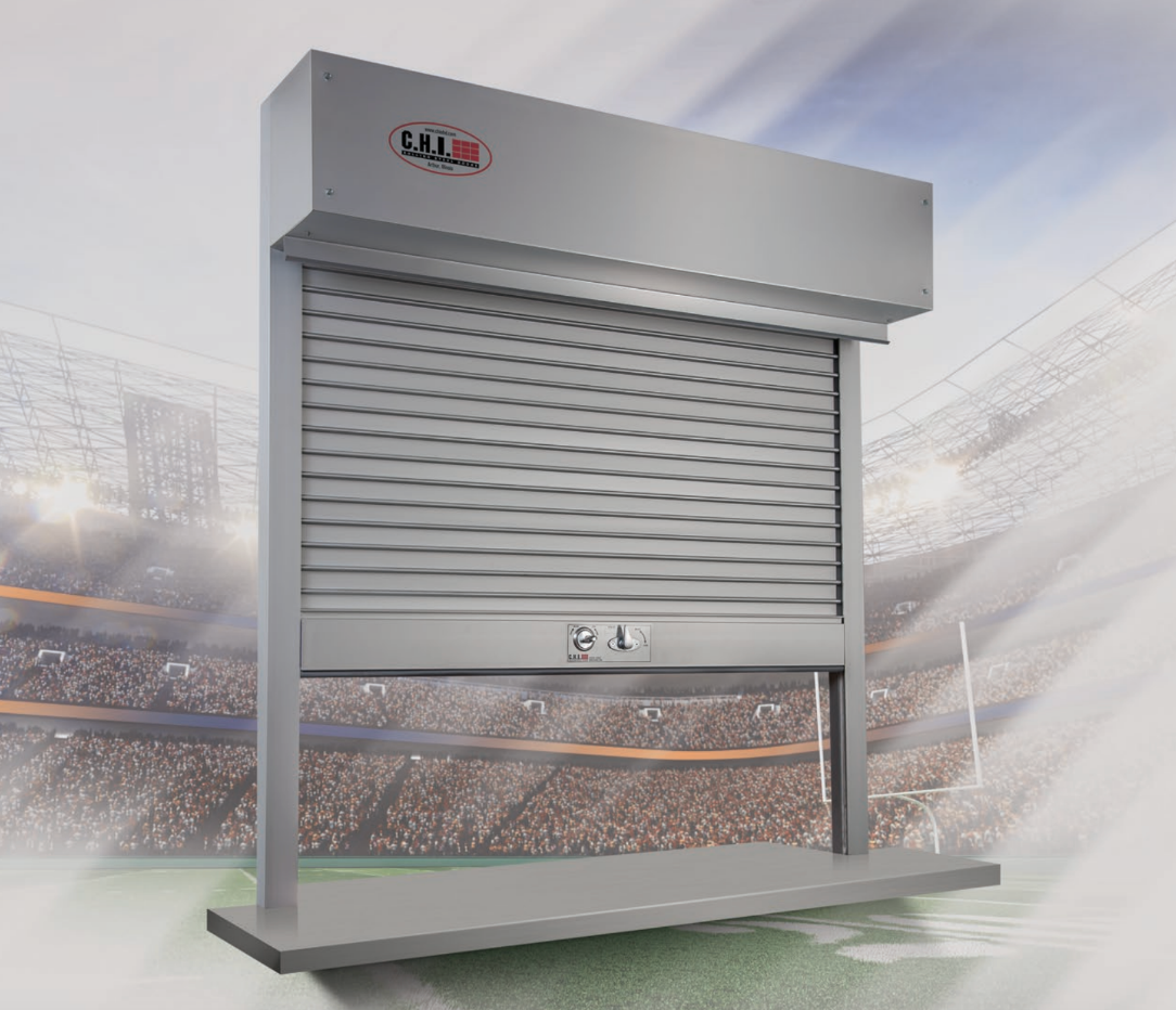 A stainless steel CHI roll-up security shutter with a control box on top, set against a stadium backdrop.