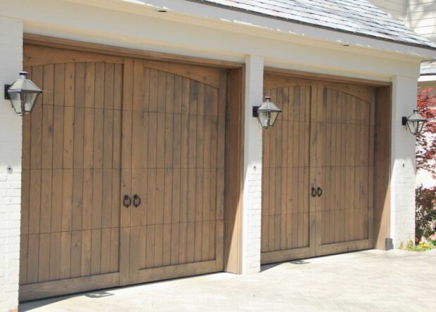 8x7-vertical-panel-wood-garage-door-with-eyebrow-trim-and-knocker-hardware