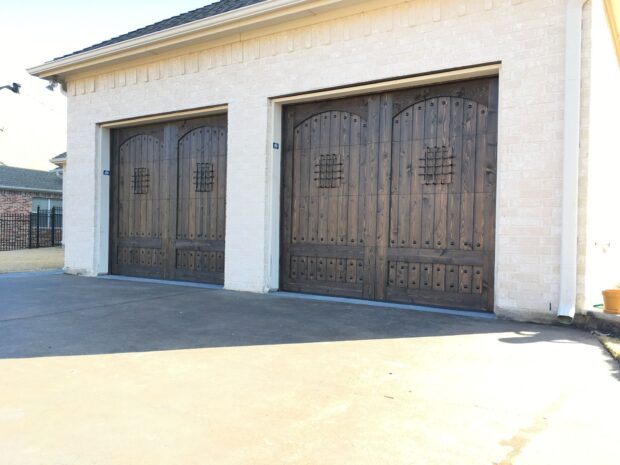 garage door with arched speakeasy and clavos